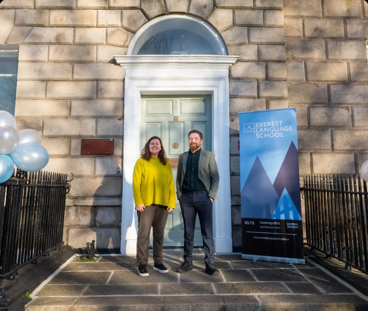 Two people outside the Everest Language School door on Merrion Square
